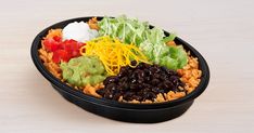 a black container filled with lots of different types of food on top of a table