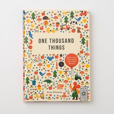 one thousand things book with illustrated illustrations on the front and back cover, against a gray background