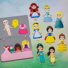 there are many different princesses on the table and one is cut out to look like dolls