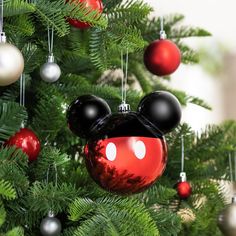 a mickey mouse ornament hanging from a christmas tree