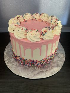 a cake with white frosting and sprinkles