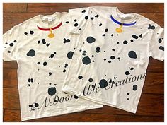 two white t - shirts with black spots on them