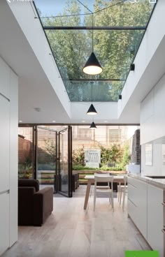 an open kitchen and dining area with skylights