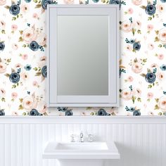 a white sink sitting under a bathroom mirror next to a wall mounted faucet