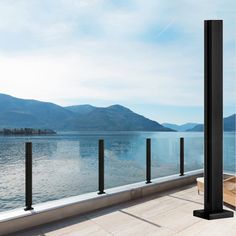 a balcony overlooking the water with mountains in the background