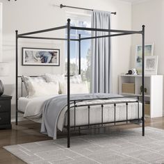 a black metal bed frame in a white bedroom