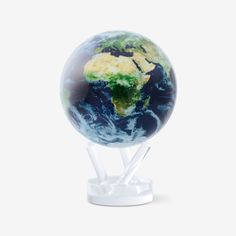 a glass globe with the earth on it's stand, against a white background