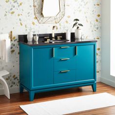 a bathroom with a blue vanity and gold accents