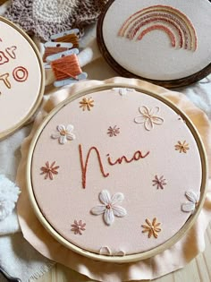 three embroidered hoops with the word mia written in cursive writing on them