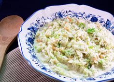 a blue and white bowl filled with cole slaw