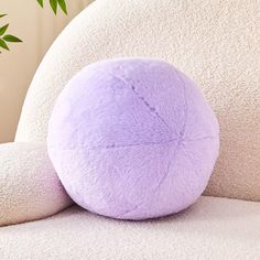 a purple ball sitting on top of a white chair