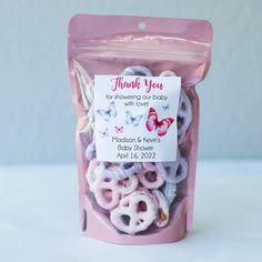 a pink bag filled with baby shower rings