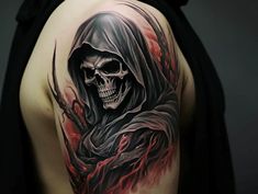 a man's back with a skull and flames tattoo on his left side shoulder