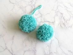 two pom - poms are sitting on a marble surface