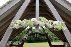 a wooden structure decorated with flowers and bunting