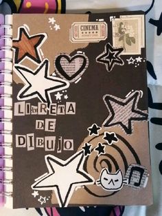 an open notebook with various stickers on it