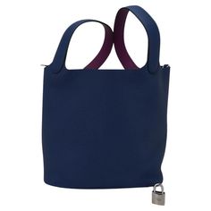 Mightychic offers an Hermes Picotin Eclat Lock 22 tote bag in Deep Blue with Anemone. The bag is Deep Blue with the interior of the handles in Anemone. The interior of the handle is Swift leather. The body of the bag and exterior handle is Clemence leather with Palladium hardware. This roomy tote is a perfect go to bag! Comes with lock and keys, sleeper, and signature Hermes box. NEW or NEVER WORN. final sale BAG MEASURES: LENGTH 22 cm / 8.5" TALL 23 cm / 9" DEEP 18 cm / 7" HANDLE: TALL 6" CONDI Satchel Bucket Bag With Palladium Hardware For Shopping, Bucket Bag With Palladium Hardware For Shopping, Hermes Fashion, Hermes Picotin, Hermes Box, Handbags And Purses, Vintage Hermes, Hermes Handbags, Lock And Key