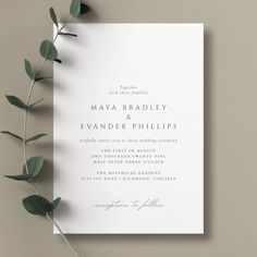 an elegant wedding card with greenery on top