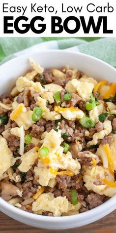 an egg bowl with meat and vegetables in it on top of a wooden table next to a green napkin