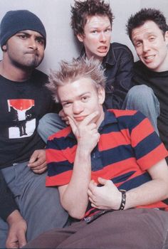 three young men sitting next to each other