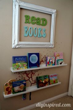 a white shelf with books on it in front of a sign that reads read books