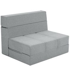 a gray couch that is sitting up against a white background