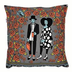 a pillow with an image of a man and woman in front of flowers on it