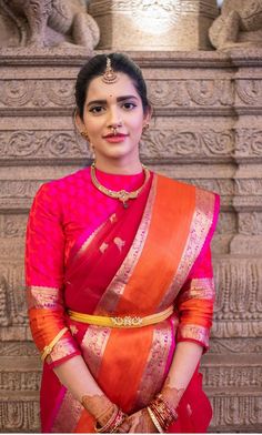 a woman in a red and orange sari