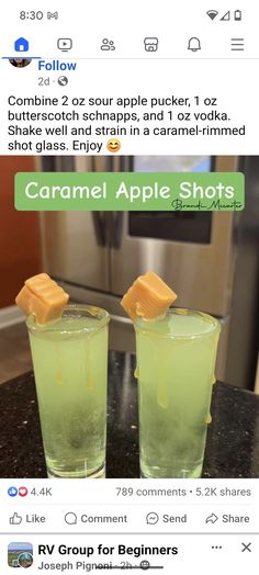 two glasses filled with green liquid sitting on top of a counter next to each other