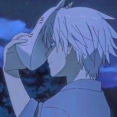 an anime character with white hair and blue eyes looking at something in the sky behind him