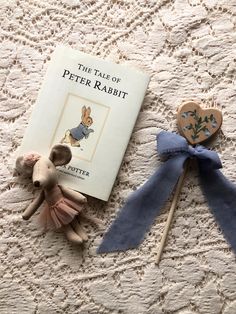 the tale of peter rabbit by beatman's globe with a teddy bear and book