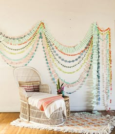 a room with a wicker bed and multicolored streamers on the wall