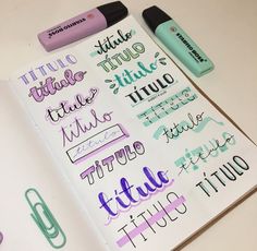 a notebook with some writing on it next to markers and pens in front of them