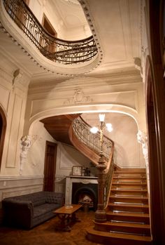 an ornate staircase in the middle of a living room