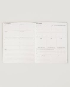 an open planner is sitting on top of a white surface with the pages lined up