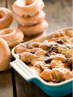 doughnuts are stacked on top of each other in a baking dish, next to a bowl of cereal