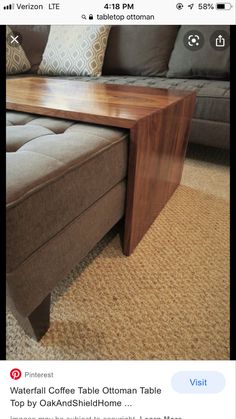 a coffee table sitting on top of a couch in a living room next to pillows