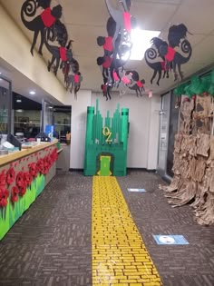 an office decorated for christmas with paper cutouts on the ceiling and decorations hanging from the ceiling