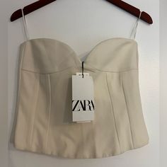 Nwt Zara Beautiful Strapless Corset Top With Sweetheart Neckline. Very Elegant !! Size M Lined New With Tags Color: Ecru Bustier With A Sweetheart Neckline And Exposed Shoulders. Invisible Back Zip Fastening. 68% Polyester 29% Viscose 3% Elastane Sz M Stock#4257 Chic White Corset With Built-in Bra, White Cami Tube Top For Party, White Fitted Bandeau Top, White Fitted Tube Top With Built-in Bra, Chic White Corset For Night Out, White Fitted Strapless Crop Top, Chic White Top With Sweetheart Neckline, White Bandeau Top For Night Out, Fitted Cream Tube Top For Summer