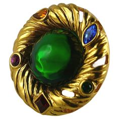 YVES SAINT LAURENT vintage gold toned "nest" brooch embellished with multicolored crystals and a large irregular-shaped green resin cabochon at the center. Embossed YSL Made in France. Indicative measurements : diameter approx. 4.6 cm (1.81 inches). NOTES - This is a preloved item, therefore it might have imperfections. - Colors may differ slightly from actual product appearance due to differences in lighting conditions. - As a buyer, you are fully responsible for customs duties, other local tax Ysl Vintage, Saint Laurent Vintage, French Fashion Designers, Diamond Brooch, Vintage Jewels, Vintage Brooch, Pearl Pendant, Vintage Brooches, Amazing Jewelry