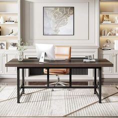 a desk with a laptop on top of it in front of some bookshelves