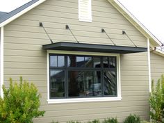 a house with a large window and an awning