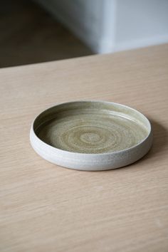 a white plate sitting on top of a wooden table