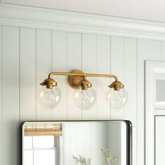 a bathroom with a mirror and lights on the wall