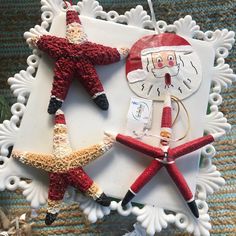 christmas ornaments are arranged in the shape of santa and starfish on a white tray