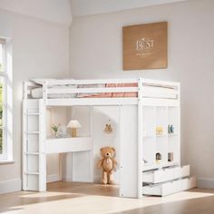 a white bunk bed with a desk underneath it and a teddy bear on the floor