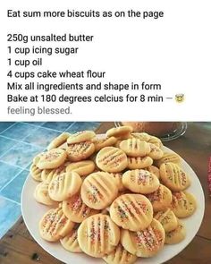 a white plate topped with cookies on top of a table next to a cupcake