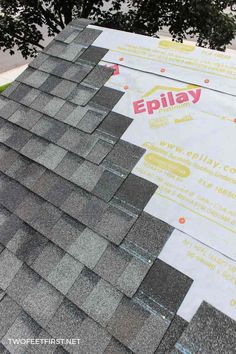 the roof is covered with asphalt shingles and signs for epilay on it