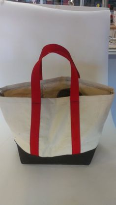 a white and red bag sitting on top of a table