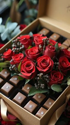 a box filled with red roses and chocolates